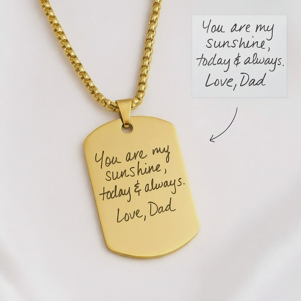 Gold necklace with engraved message on a white background