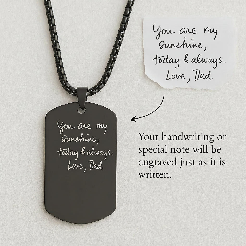 Black dog tag necklace with engraved message on a white background